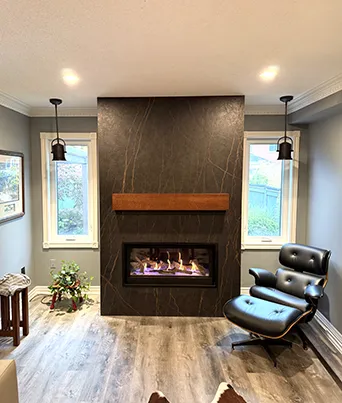 Floor-to-ceiling statement slab, custom wood mantel, built-in fireplace and contemporary feature wall